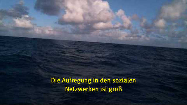 Webcam-Foto vom Meer, untertitelt mit gelber Schrift: "Die Aufregung in den sozialen Netzwerken ist groß"