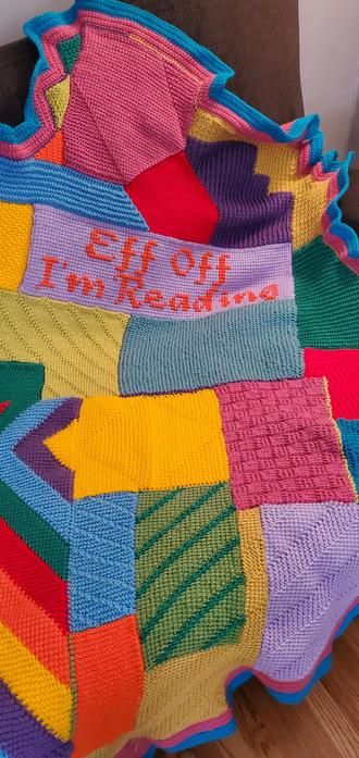 Close-up of our latest colourful wacky afghan creation, including a cross-stitched segment that reads "Eff Off I'm Reading" ...